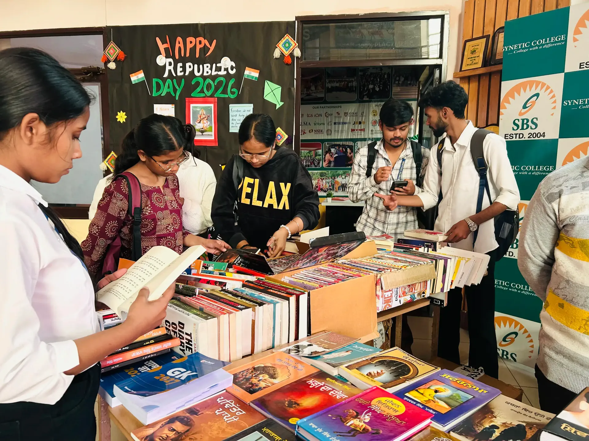 Book fair at SBS — students browsing books, stalls, vibrant campus setting